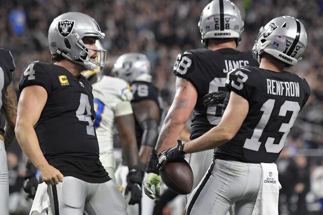 Las Vegas Raiders quarterback Derek Carr (4) celebrates after wide receiver Hunter Renfrow (13) scored a touchdown against the Los Angeles Chargers during the second half of an NFL football game, Sunday, Jan. 9, 2022, in Las Vegas. (AP Photo/David Becker)