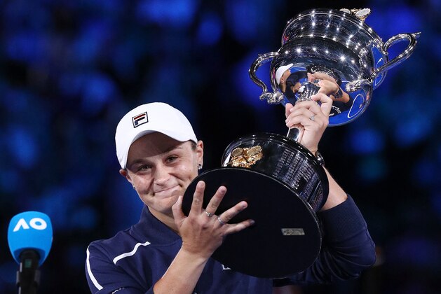Australia's Ashleigh Barty poses with the trophy after victory in her womens singles final match against Danielle Collins of the US on day thirteen of the Australian Open tennis tournament in Melbourne on January 29, 2022. - -- IMAGE RESTRICTED TO EDITORIAL USE - STRICTLY NO COMMERCIAL USE -- (Photo by Aaron FRANCIS / AFP) / -- IMAGE RESTRICTED TO EDITORIAL USE - STRICTLY NO COMMERCIAL USE -- (Photo by AARON FRANCIS/AFP via Getty Images)