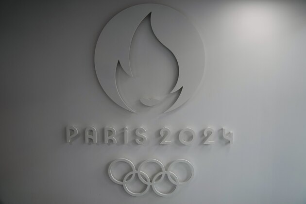 The logo of the Paris 2024 Organizing Committee, is pictured at the headquarters in Saint Denis, outside Paris, Thursday, Oct.14, 2021. French President Emmanuel Macron said Thursday that the government will help fund 5,000 local facilities to allow more people to practice sports, especially in the country's poorest areas, ahead of the Paris 2024 Olympics. (AP Photo/Francois Mori)