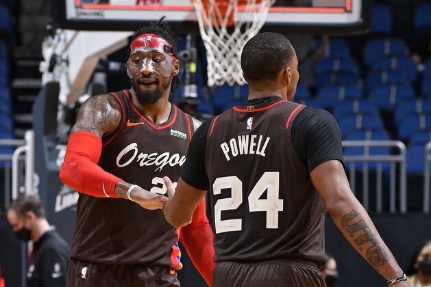ORLANDO, FL - MARCH 26: Robert Covington #23 of the Portland Trail Blazers high fives Norman Powell #24 of the Portland Trail Blazers during the game against the Orlando Magic on March 26, 2021 at Amway Center in Orlando, Florida. NOTE TO USER: User expressly acknowledges and agrees that, by downloading and or using this photograph, User is consenting to the terms and conditions of the Getty Images License Agreement. Mandatory Copyright Notice: Copyright 2021 NBAE (Photo by Fernando Medina/NBAE via Getty Images)