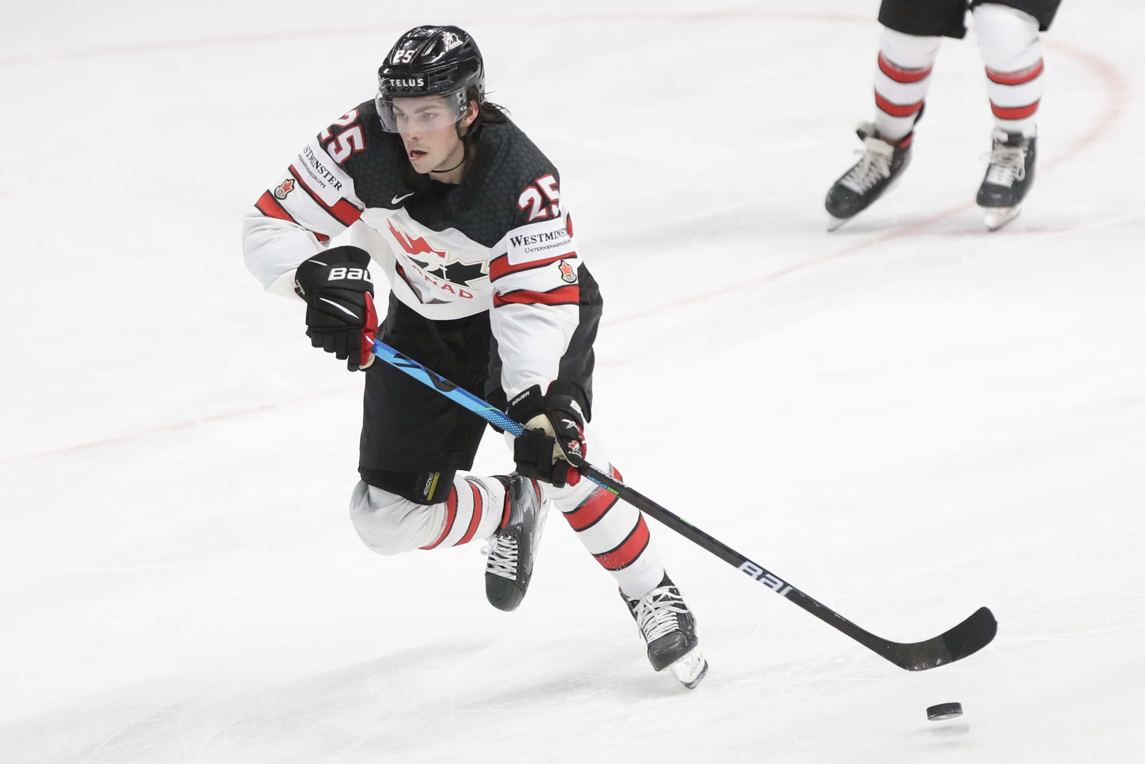 Canada's Owen Power controls the puck during the Ice Hockey World Championship semifinal match between the United States and Canada at the Arena in Riga, Latvia, Saturday, June 5, 2021. (AP Photo/Sergei Grits)