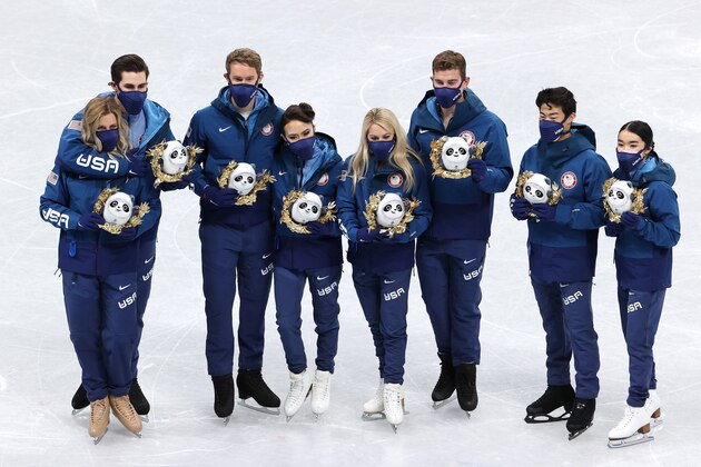 BEIJING, CHINA - FEBRUARY 07: Silver medalists Alexa Knierim, Brandon Frazier, Madison Chock, Evan Bates, Karen Chen, Nathan Chen, Vincent Zhou, Madison Hubbell, Zachary Donohue of Team United States celebrate during the Team Event flower ceremony on day three of the Beijing 2022 Winter Olympic Games at Capital Indoor Stadium on February 07, 2022 in Beijing, China. (Photo by Jean Catuffe/Getty Images)