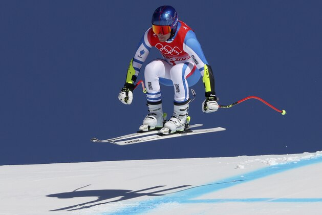 Alexis Pinturault of France makes a jump during the men's super-G at the 2022 Winter Olympics, Tuesday, Feb. 8, 2022, in the Yanqing district of Beijing. (AP Photo/Alessandro Trovati)