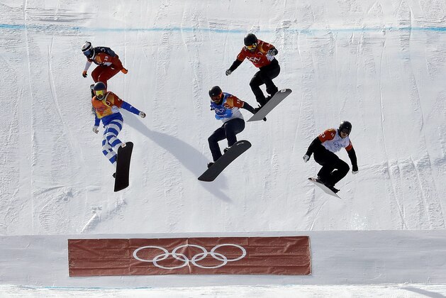From left; Mateusz Ligocki, of Poland, Emanuel Perathoner, of Italy, Nick Baumgartner, of the United States,Martin Noerl, of Germany, and Anton Lindfors, of Finland, run the course during the men's snowboard cross quarterfinal at Phoenix Snow Park at the 2018 Winter Olympics in Pyeongchang, South Korea, Thursday, Feb. 15, 2018. (AP Photo/Lee Jin-man)