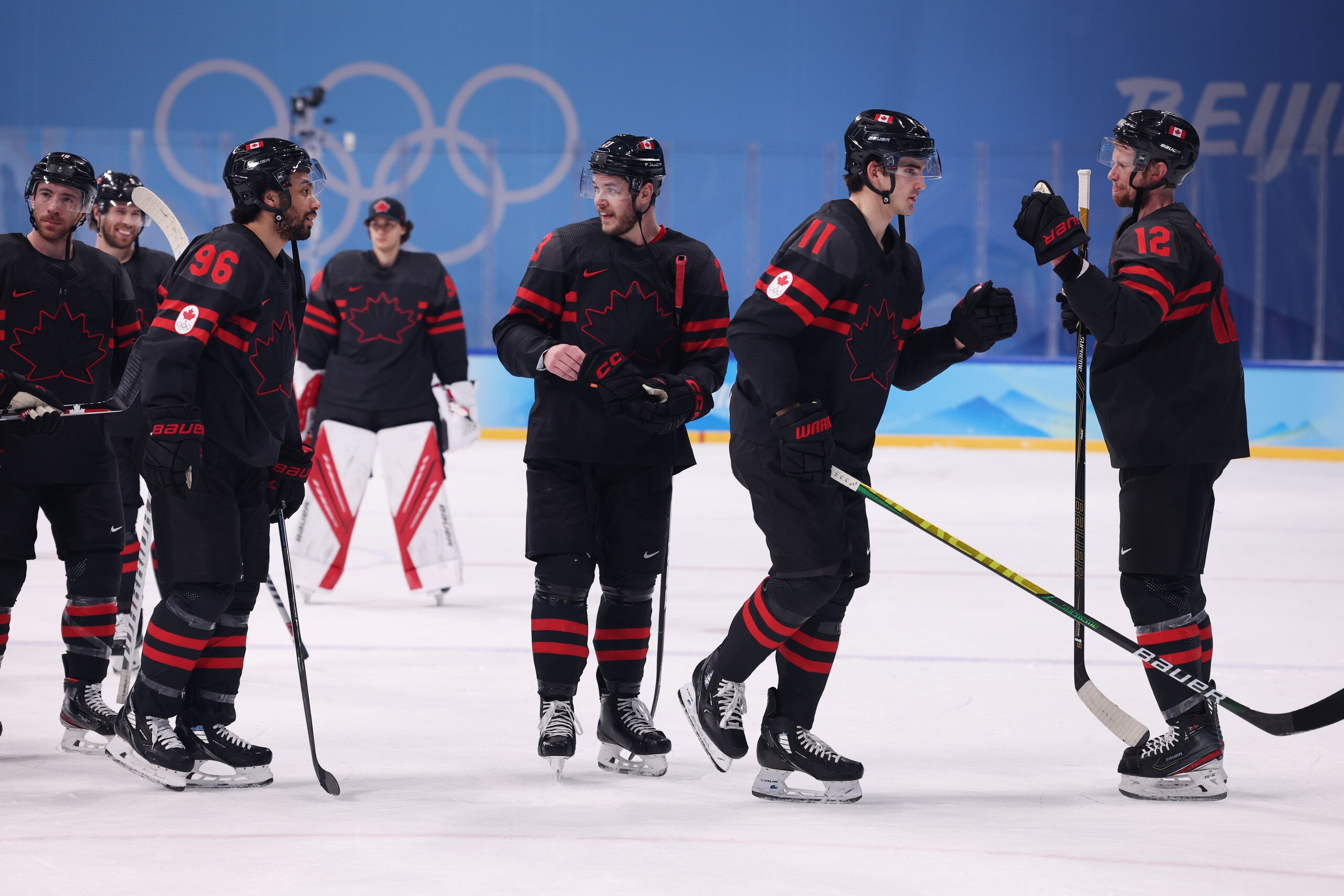 BEIJING, CHINA - FEBRUARY 10: (R-L) Eric Staal #12, Jack McBain #11, Tyler Wotherspoon #23 and Josh Ho-Sang #96 of Team Canada celebrate after defeating Team Germany 5-1 in the Men's Ice Hockey Preliminary Round Group A match on Day 6 of the Beijing 2022 Winter Olympic Games at Wukesong Sports Centre on February 10, 2022 in Beijing, China. (Photo by Harry How/Getty Images)