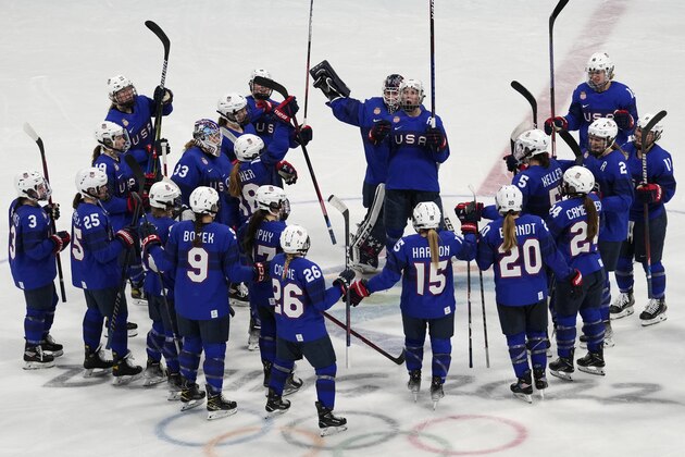 Members of the United States team celebrate wining the women's quarterfinal hockey game against the Czech Republic at the 2022 Winter Olympics, Friday, Feb. 11, 2022, in Beijing. (AP Photo/Petr David Josek)