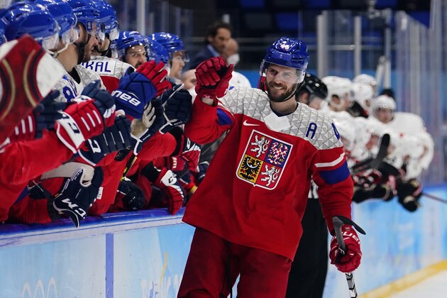 Czech Republic's David Krejci (46) is congratulated after scoring the winning shoot-out goal against Switzerland during a preliminary round men's hockey game at the 2022 Winter Olympics, Friday, Feb. 11, 2022, in Beijing. (AP Photo/Matt Slocum)