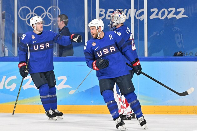 USA's Steven Kampfer (R) celebrates after scoring an equalizer during the men's preliminary round group A match of the Beijing 2022 Winter Olympic Games ice hockey competition between USA and Germany, at the Wukesong Sports Centre in Beijing on February 13, 2022. (Photo by ANTHONY WALLACE / AFP) (Photo by ANTHONY WALLACE/AFP via Getty Images)