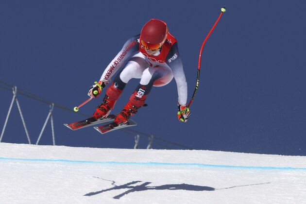 Mikaela Shiffrin, of the United States makes a jump during women's downhill training at the 2022 Winter Olympics, Monday, Feb. 14, 2022, in the Yanqing district of Beijing. (AP Photo/Alessandro Trovati)