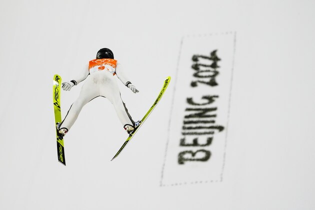 Ursa Bogataj, of Slovenia, soars through the air during the mixed team trial round at the 2022 Winter Olympics, Monday, Feb. 7, 2022, in Zhangjiakou, China. (AP Photo/Matthias Schrader)