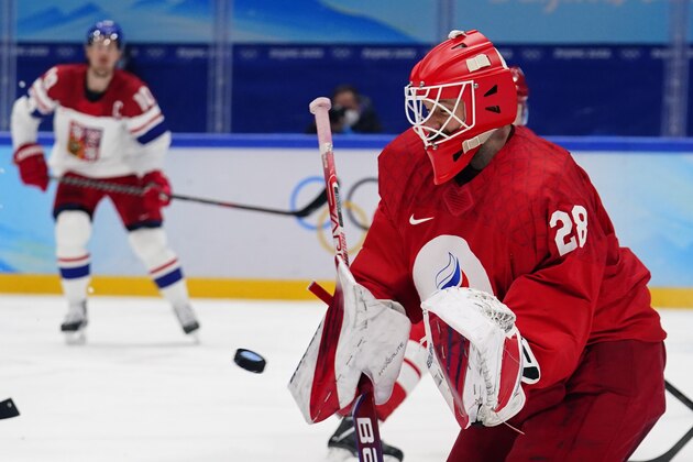 Russian Olympic Committee goalkeeper Ivan Fedotov (28) reaches for a shot during a preliminary round men's hockey game against Czech Republic at the 2022 Winter Olympics, Saturday, Feb. 12, 2022, in Beijing. (AP Photo/Matt Slocum)