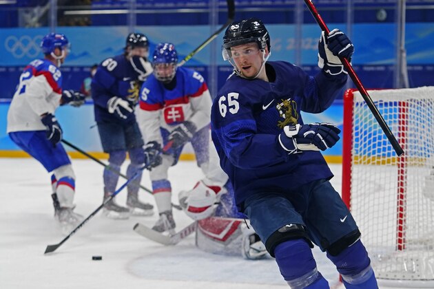 Finland's Sakari Manninen (65) skates to the bench after scoring a goal against Slovakia during a preliminary round men's hockey game at the 2022 Winter Olympics, Thursday, Feb. 10, 2022, in Beijing. (AP Photo/Matt Slocum)
