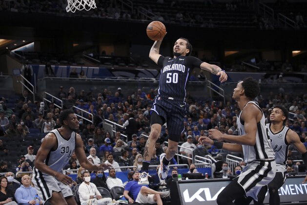 Orlando Magic guard Cole Anthony goes up for a dunk in front of San Antonio Spurs defenders, including forward Thaddeus Young, left, during the second half of an NBA basketball game Friday, Nov. 5, 2021, in Orlando, Fla. (AP Photo/Jacob M. Langston)