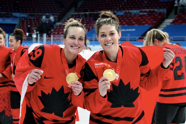 BEIJING, CHINA - FEBRUARY 17: Marie-Philip Poulin #29 and Rebecca Jonhston #6 Team Canada celebrates their gold medals after winning the Women's Ice Hockey Gold Medal match between Team Canada and Team United States on Day 13 of the Beijing 2022 Winter Olympic Games at Wukesong Sports Centre on February 17, 2022 in Beijing, China. (Photo by Xavier Laine/Getty Images)