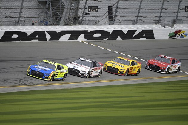Ryan Blaney (12), Austin Cindric (2), Joey Logano (22) and Harrison Burton (21) run laps during practice for the Daytona 500 auto race at Daytona International Speedway, Saturday, Feb. 19, 2022, in Daytona Beach, Fla. (AP Photo/Phelan M. Ebenhack)