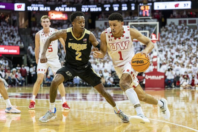 Wisconsin's Johnny Davis (1) and Purdue's Eric Hunter (2) during the second half of an NCAA college basketball game Tuesday, March 1, 2022, in Madison, Wis. Wisconsin upset Purdue 70-67. (AP Photo/Andy Manis)