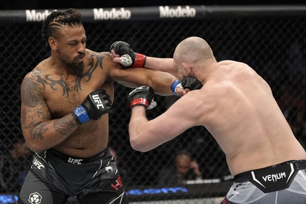 LAS VEGAS, NEVADA - MARCH 05: (L-R) Greg Hardy punches Serghei Spivac of Moldova in their heavyweight fight during the UFC 272 event on March 05, 2022 in Las Vegas, Nevada. (Photo by Jeff Bottari/Zuffa LLC)