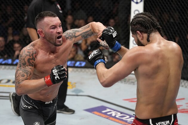 LAS VEGAS, NEVADA - MARCH 05: (L-R) Colby Covington punches Jorge Masvidal in their welterweight fight during the UFC 272 event on March 05, 2022 in Las Vegas, Nevada. (Photo by Jeff Bottari/Zuffa LLC)