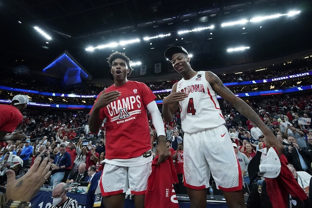 Arizona's Justin Kier, left, and Dalen Terry (4) celebrate after defeating UCLA in an NCAA college basketball game in the championship of the Pac-12 tournament Saturday, March 12, 2022, in Las Vegas. (AP Photo/John Locher)
