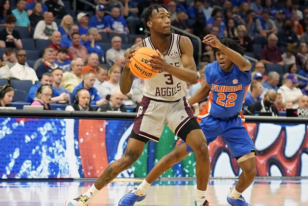 Texas A&M guard Quenton Jackson (3) looks to pass the ball against Florida guard Tyree Appleby (22) during the first half of an NCAA men's college basketball game at the Southeastern Conference tournament in Tampa, Fla., Thursday, March 10, 2022. (AP Photo/Chris O'Meara)