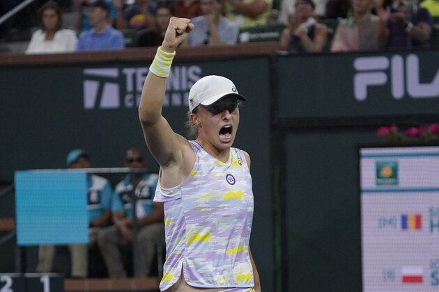 Iga Swiatek, of Poland, reacts after winning a game during her women's singles semifinals match against Simona Halep, of Romania, at the BNP Paribas Open tennis tournament Friday, March 18, 2022, in Indian Wells, Calif. (AP Photo/Mark J. Terrill)