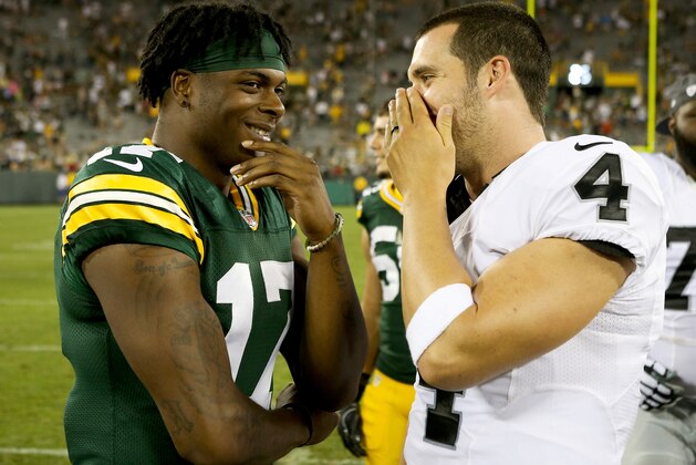 GREEN BAY, WI - AUGUST 18:  Davante Adams #17 of the Green Bay Packers and Derek Carr #4 of the Oakland Raiders chat after the preseason game at Lambeau Field on August 18, 2016 in Green Bay, Wisconsin. (Photo by Dylan Buell/Getty Images)