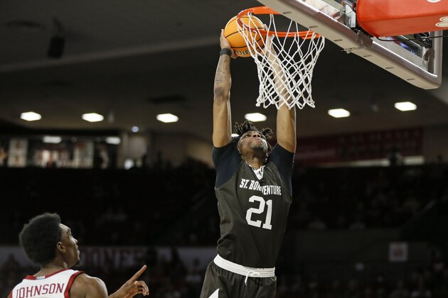 St. Bonaventure forward Osun Osunniyi (21) dunks near Oklahoma guard Marvin Johnson in the first half of an NCAA college basketball game in the second round of the NIT in Norman, Okla., Sunday, March 20, 2022. (AP Photo/Nate Billings)