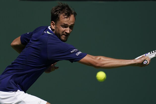 Daniil Medvedev, of Russia, returns a shot to Gael Monfils, of France, at the BNP Paribas Open tennis tournament Monday, March 14, 2022, in Indian Wells, Calif. (AP Photo/Marcio Jose Sanchez)