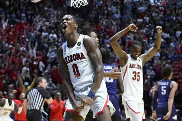 Arizona guard Bennedict Mathurin (0) and center Christian Koloko (35) react at the end of overtime in a second-round NCAA college basketball tournament game against TCU, Sunday, March 20, 2022, in San Diego. Arizona won 85-80. (AP Photo/Denis Poroy)