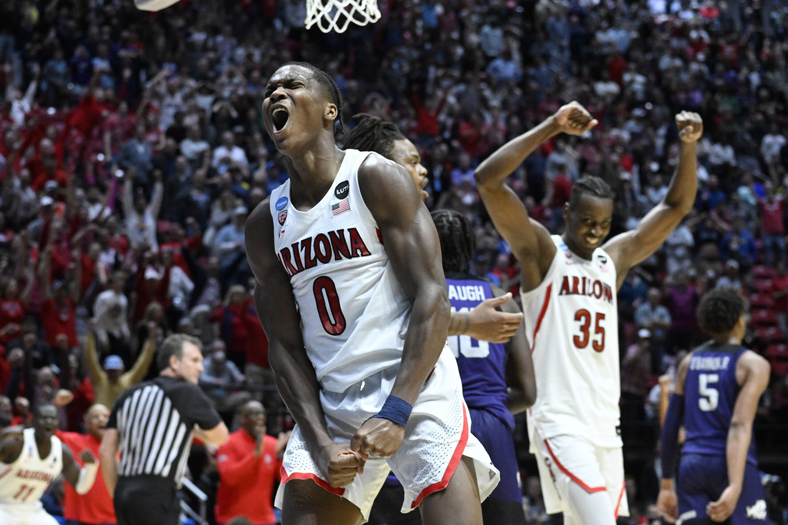 Arizona guard Bennedict Mathurin (0) and center Christian Koloko (35) react at the end of overtime in a second-round NCAA college basketball tournament game against TCU, Sunday, March 20, 2022, in San Diego. Arizona won 85-80. (AP Photo/Denis Poroy)