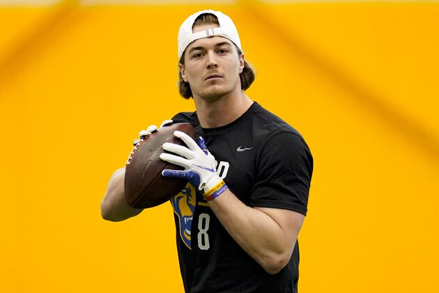 Quarterback Kenny Pickett (8) goes through passing drills during Pittsburgh's football pro day, Monday, March 21, 2022, in Pittsburgh. (AP Photo/Keith Srakocic)