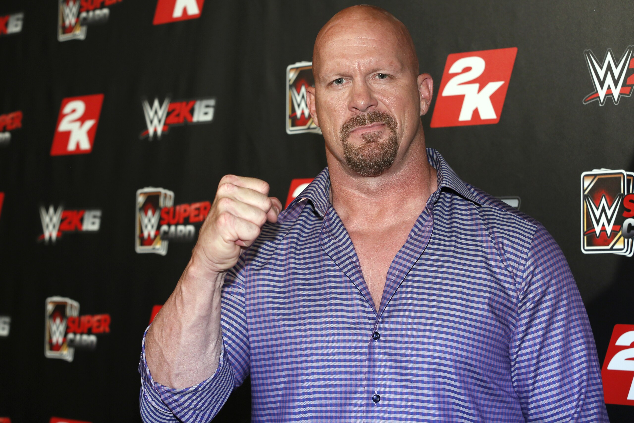 IMAGE DISTRIBUTED FOR 2K - WWE Hall of Famer and WWE 2K16 cover, Superstar Stone Cold Steve Austin arrives on the red carpet at the WWE 2K SummerSlam Kickoff in New York, N.Y., on Thursday, Aug. 20, 2015. (Photo by Stuart Ramson/Invision for 2K/AP Images)