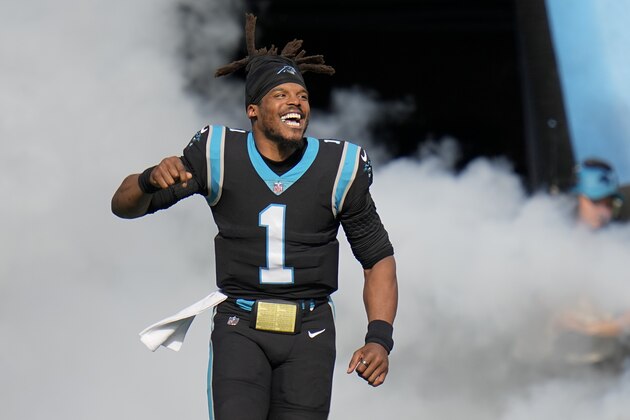 Carolina Panthers quarterback Cam Newton runs onto the field before an NFL football game against the Tampa Bay Buccaneers Sunday, Dec. 26, 2021, in Charlotte, N.C. (AP Photo/Rusty Jones)