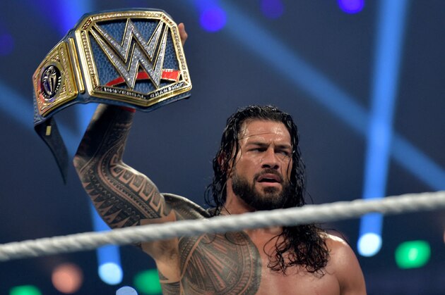 Roman Reigns celebrates after defeating Bill Goldberg during the 2022 WWE Elimination Chamber at the Jeddah Super Dome in Saudi Arabia's Red Sea coastal city of Jeddah on February 19, 2022. (Photo by Amer HILABI / AFP) (Photo by AMER HILABI/AFP via Getty Images)