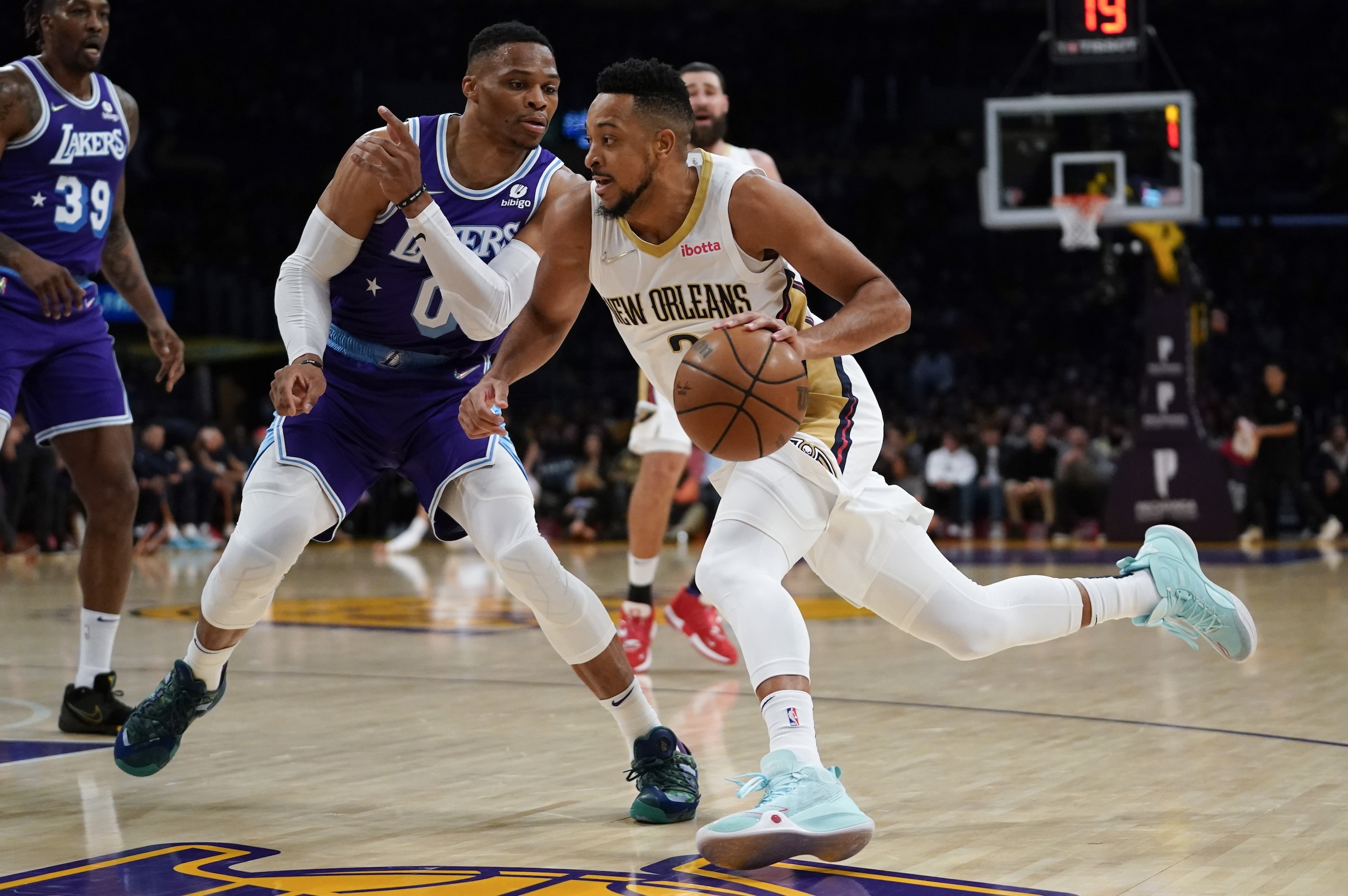 New Orleans Pelicans guard CJ McCollum (3) drives the ball against Los Angeles Lakers guard Russell Westbrook (0) during the first half of an NBA basketball game in Los Angeles, Friday, April 1, 2022. (AP Photo/Ashley Landis) New Orleans Pelicans guard CJ McCollum (3) drives the ball against Los Angeles Lakers guard Russell Westbrook (0) during the first half of an NBA basketball game in Los Angeles, Friday, April 1, 2022. (AP Photo/Ashley Landis)