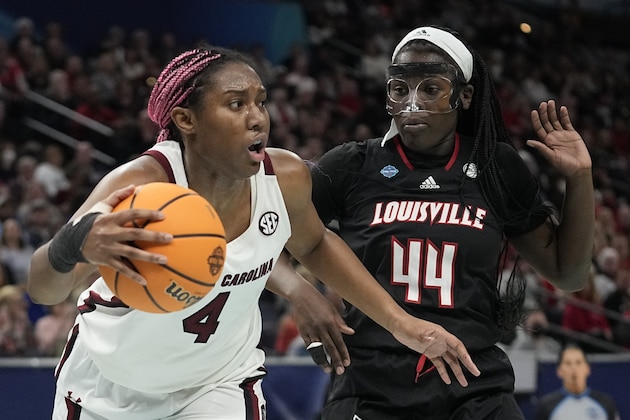 South Carolina's Aliyah Boston drives pasr Louisville's Olivia Cochran during the first half of a college basketball game in the semifinal round of the Women's Final Four NCAA tournament Friday, April 1, 2022, in Minneapolis. (AP Photo/Eric Gay)