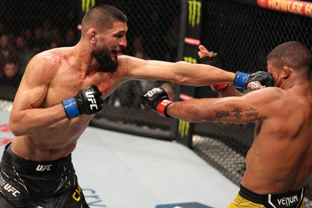JACKSONVILLE, FLORIDA - APRIL 09: (L-R) Khamzat Chimaev of Russia punches Gilbert Burns of Brazil in their welterweight fight during the UFC 273 event at VyStar Veterans Memorial Arena on April 09, 2022 in Jacksonville, Florida. (Photo by Jeff Bottari/Zuffa LLC)
