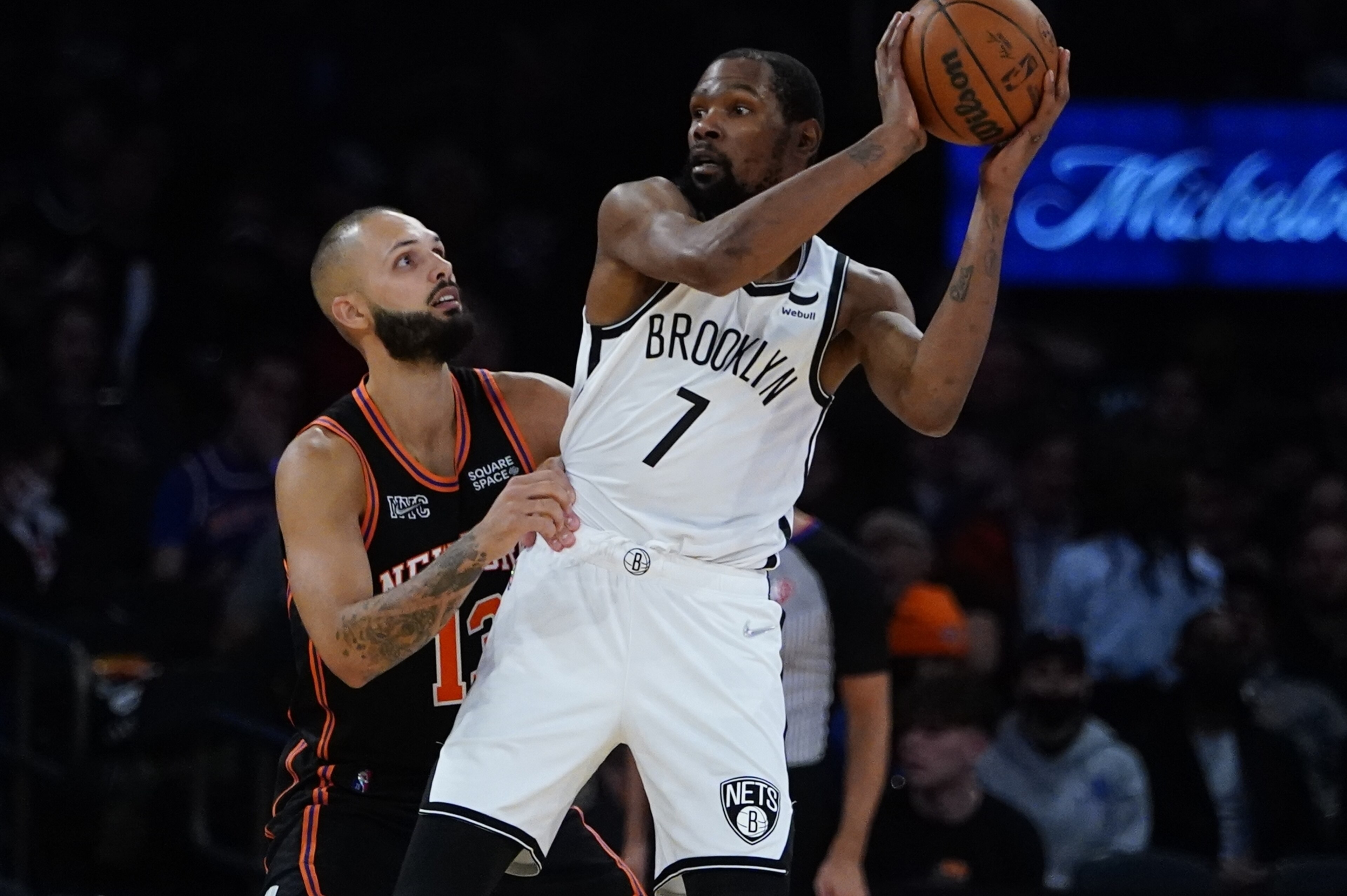New York Knicks' Evan Fournier (13) defends Brooklyn Nets' Kevin Durant (7) during the second half of an NBA basketball game Wednesday, April 6, 2022, in New York. The Nets won 110-98. (AP Photo/Frank Franklin II) New York Knicks' Evan Fournier (13) defends Brooklyn Nets' Kevin Durant (7) during the second half of an NBA basketball game Wednesday, April 6, 2022, in New York. The Nets won 110-98. (AP Photo/Frank Franklin II)