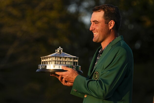 Scottie Scheffler holds the championship trophy after winning the 86th Masters golf tournament on Sunday, April 10, 2022, in Augusta, Ga. (AP Photo/Robert F. Bukaty)