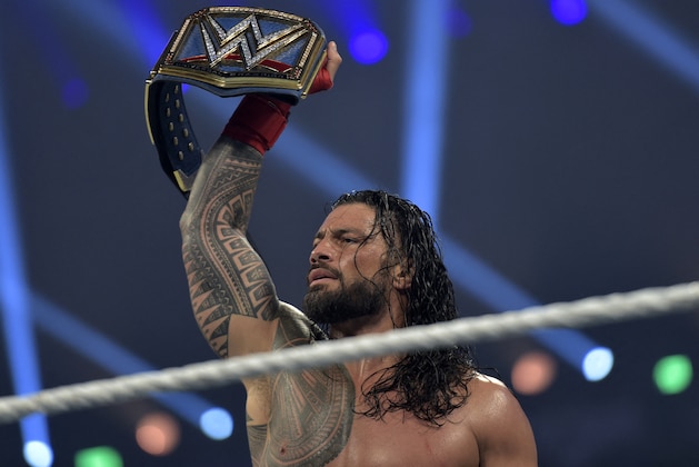 Roman Reigns celebrates after defeating Bill Goldberg during the 2022 WWE Elimination Chamber at the Jeddah Super Dome in Saudi Arabia's Red Sea coastal city of Jeddah on February 19, 2022. (Photo by Amer HILABI / AFP) (Photo by AMER HILABI/AFP via Getty Images)