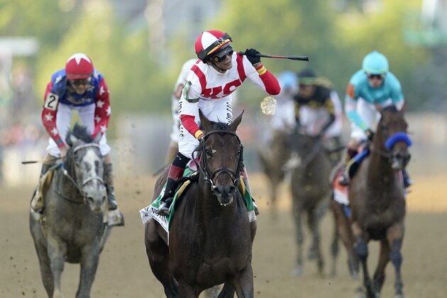 Jose Ortiz, center, atop Early Voting, reacts after winning the 147th running of the Preakness Stakes horse race at Pimlico Race Course, Saturday, May 21, 2022, in Baltimore. (AP Photo/Nick Wass)