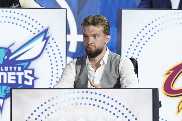 Sacramento Kings' Domantas Sabonis sits on stage during the 2022 NBA basketball Draft Lottery Tuesday, May 17, 2022, in Chicago. (AP Photo/Charles Rex Arbogast)