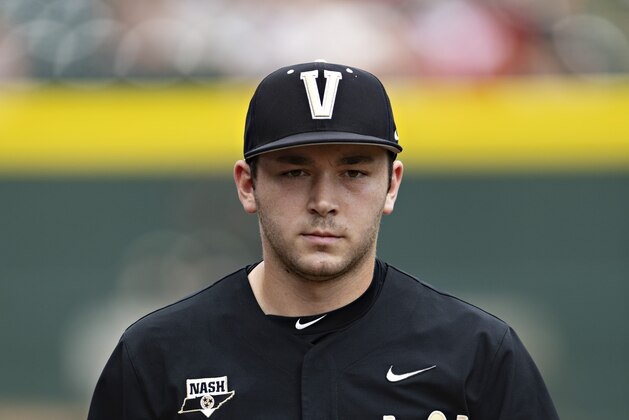 FAYETTEVILLE, ARKANSAS - MAY 15: Carter Holton #20 of the Vanderbilt Commodores walks to the dugout during the third and final game of a series against the Arkansas Razorbacks at Baum-Walker Stadium at George Cole Field on May 15, 2022 in Fayetteville, Arkansas. The Commodores defeated the Razorbacks 5-0. (Photo by Wesley Hitt/Getty Images)