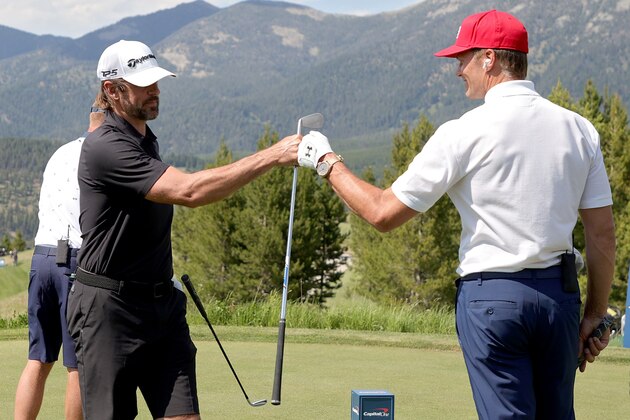 BIG SKY, MONTANA - JULY 06: Aaron Rodgers (L) and Tom Brady fist bump on the second tee during Capital One's The Match at The Reserve at Moonlight Basin on July 06, 2021 in Big Sky, Montana. (Photo by Stacy Revere/Getty Images for The Match)