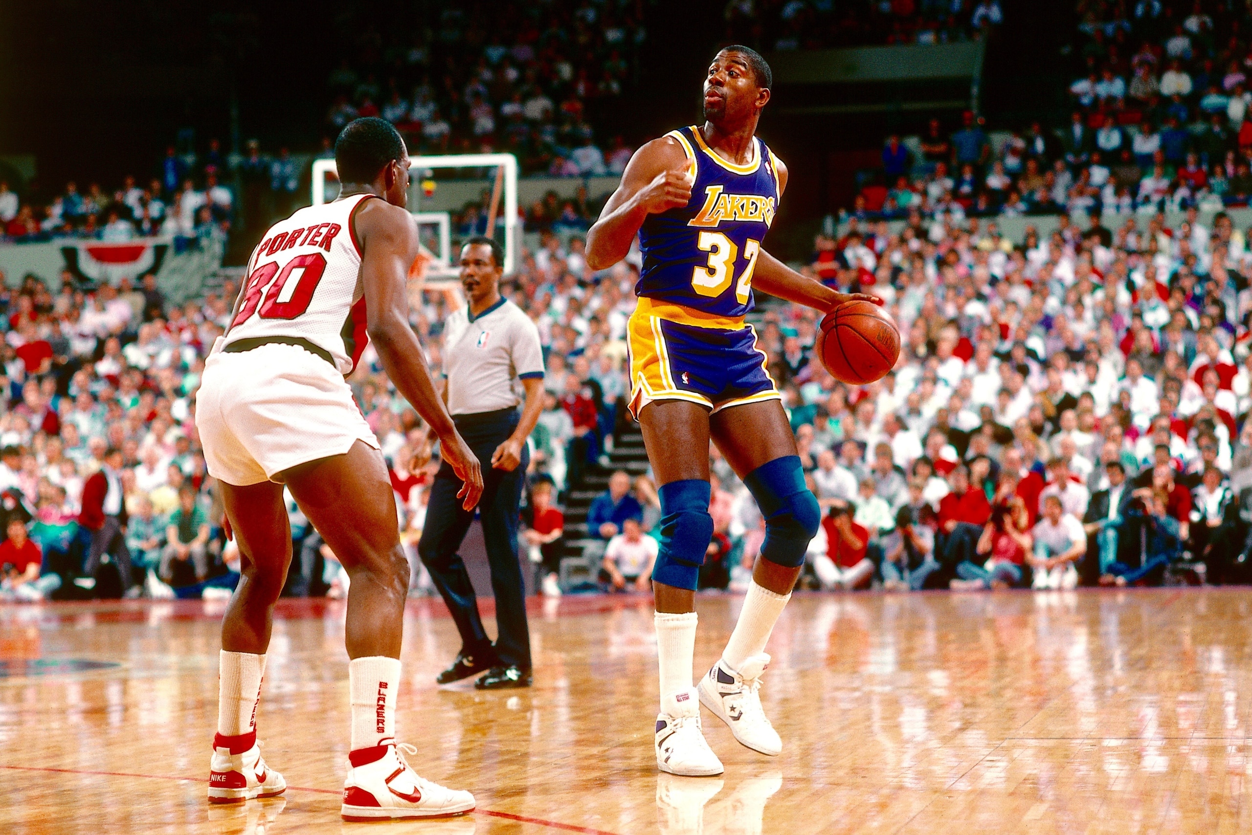 LOS ANGELES - 1987:  Magic Johnson #32 of the Los Angeles Lakers dribbles the ball during an NBA game at the Great Western Forum in Los Angeles, California in 1987. (Photo by: Rick Stewart/Getty Images)
