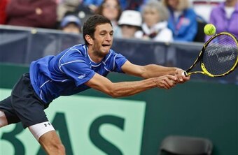 Britain's James Ward returns a shot to Sam Querrey, of the United States, during a Davis Cup tennis match Friday, Jan. 31, 2014, in San Diego. (AP Photo/Lenny Ignelzi)