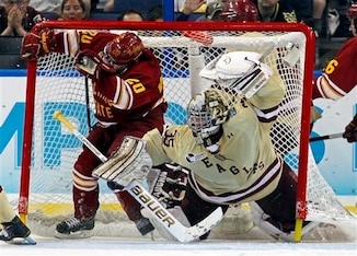 Ferris State's Matthew Kirzinger, left, crashes the net of Boston College goalie Parker Milner during the second period of the NCAA Frozen Four college hockey tournament final, Saturday, April 7, 2012, in Tampa, Fla. (AP Photo/Mike Carlson)