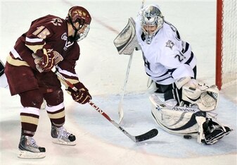 New Hampshire goaltender Brian Foster, right, stops this breakaway-attempt by Boston College forward Joe Whitney during the second period of an NCAA college hockey game at the Whittemore Center Arena in Durham, N.H., Friday, March 5, 2010. (AP Photo/Josh 