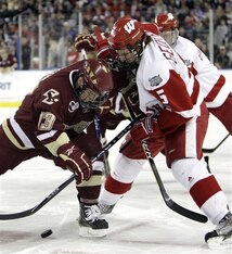 Boston College's Cam Atkinson, left, and Wisconsin's Blake Geoffrion battle for the puck in the second period of their NCAA Frozen Four championship hockey game in Detroit, Saturday, April 10, 2010. (AP Photo/Paul Sancya)