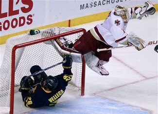 Boston College's John Muse, right, jumps to avoid Merrimack's Jeff Velleca as he slides into the net in the third period of the Hockey East tournament championship hockey game, Saturday, March 19, 2011, in Boston. Boston College won 5-3. (AP Photo/Michael
